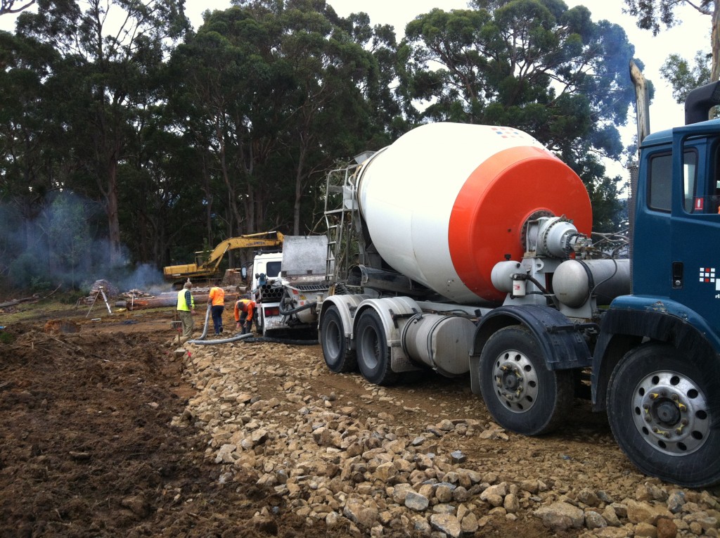 The pump truck and concrete truck on the freshly made driveway