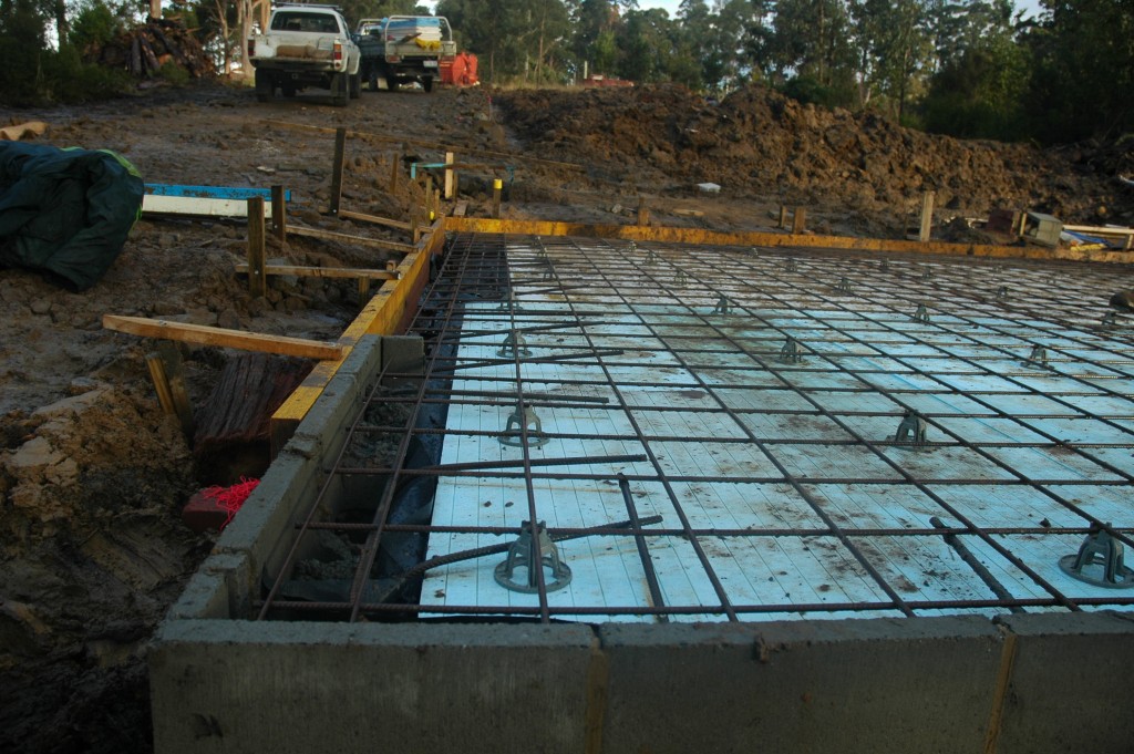 The steel reinforcing in place and straight edge formed for the concrete slab to be poured