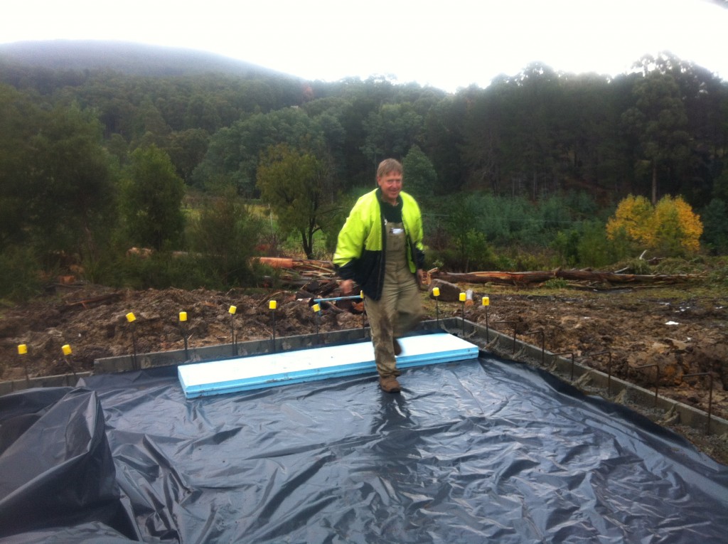 Is that a smile? First piece of floor insulation in place