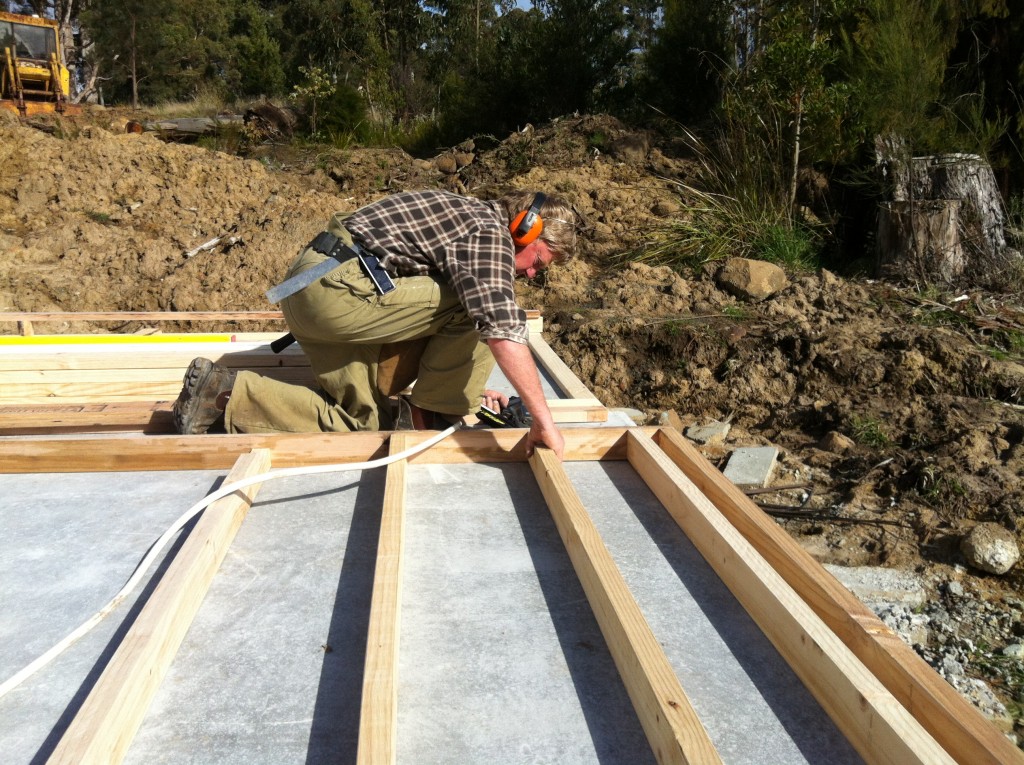 Kapow! Greg using the nail gun to assemble the wall