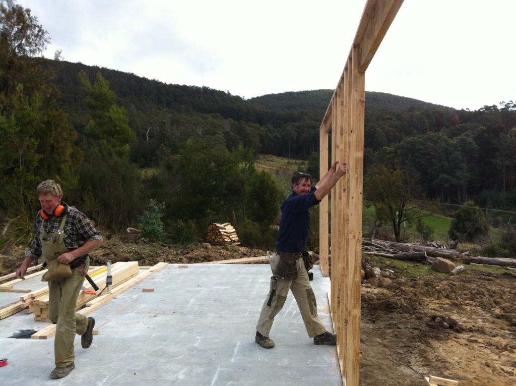 Smiles all round! The first wall is lifted into place