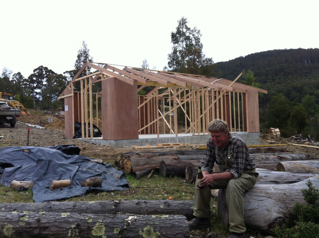 A well earned thirst: after three solid days the walls were up and the roof trusses were on