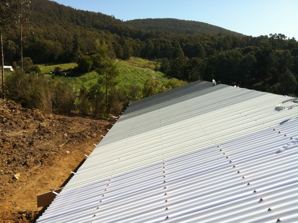 Looking over the roof to the apple orchard and valley beyond