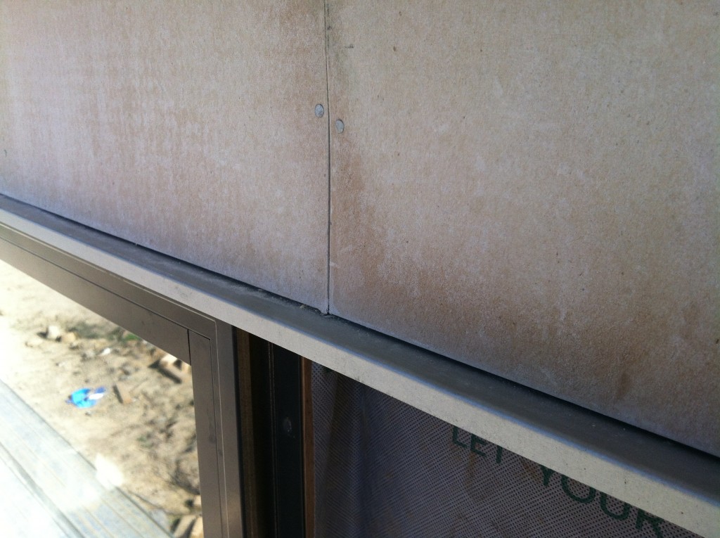 Neat detail: cement sheet cladding, flashing, window head