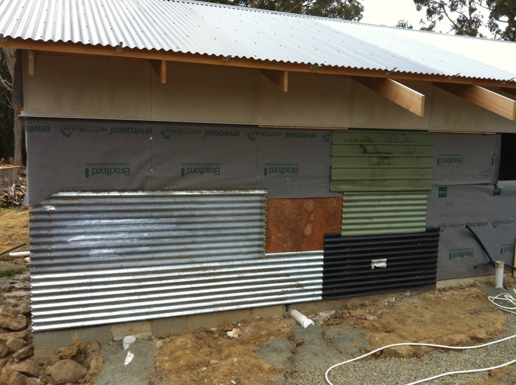 Assortment: second hand sheets of roofing used to enclose the building to protect the timber floor