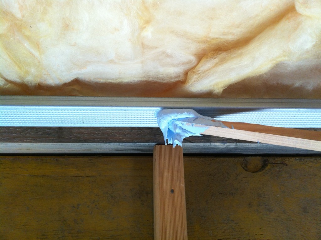 Stick it: applying the adhesive to stick the plasterboard to the metal furring