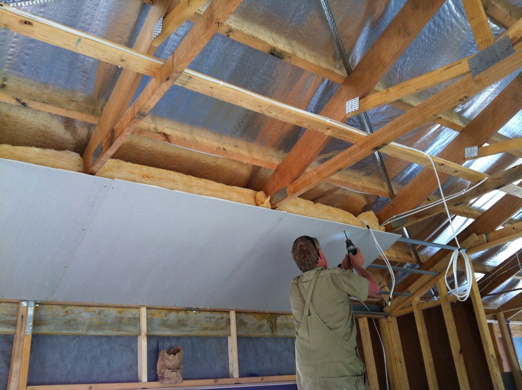 As well as the adhesive the sheets of plaster are also fixed with screws, which are then plastered over for a smooth finish