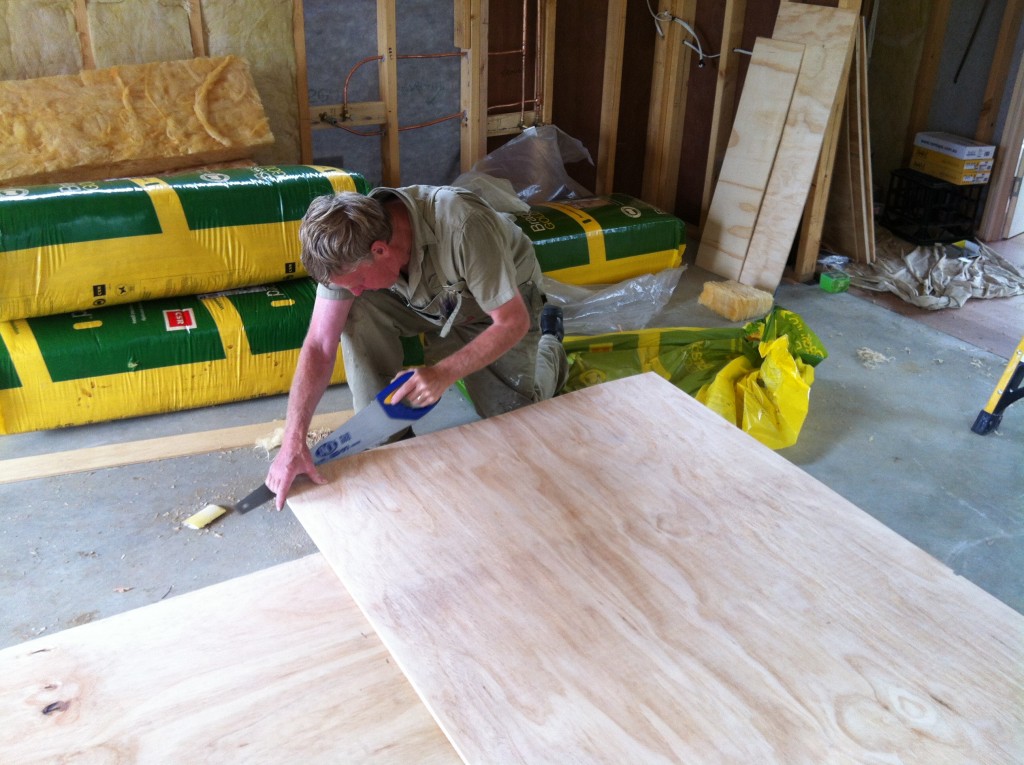 Straight cut: Greg cutting an edge of sheet with a hand saw