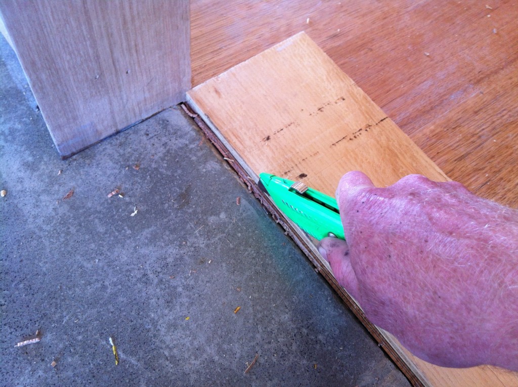 A thousand cuts: cutting the ends of the floor boards to make way for a a bead of silicone where the two materials meet