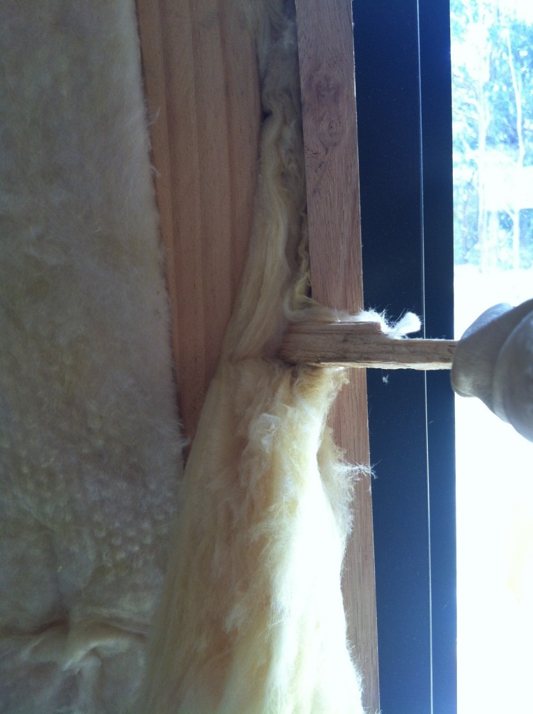 Poker: stuffing the batts in between the stud and window frame