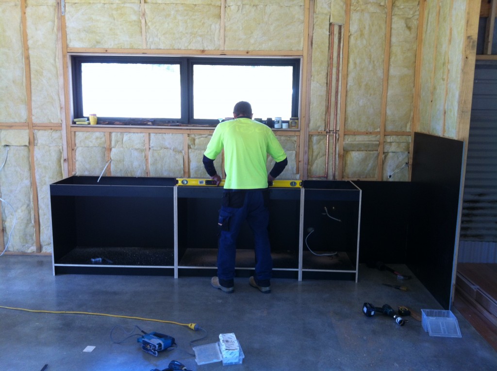 On the level: Mark leveling the kitchen units. He said the floor was one of the flattest he had ever seen