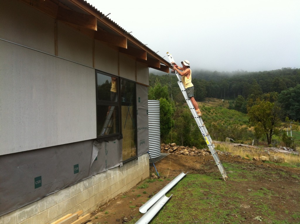 Last one: Ian fixing the final gutter bracket in place