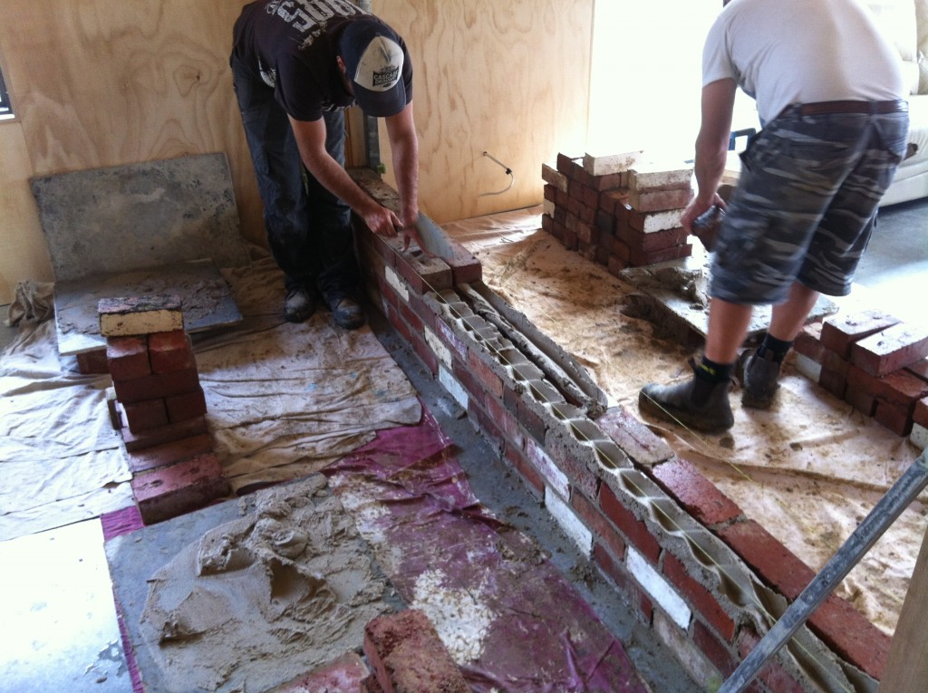 Going up: Trent and Scott laying the first courses of the brickwork