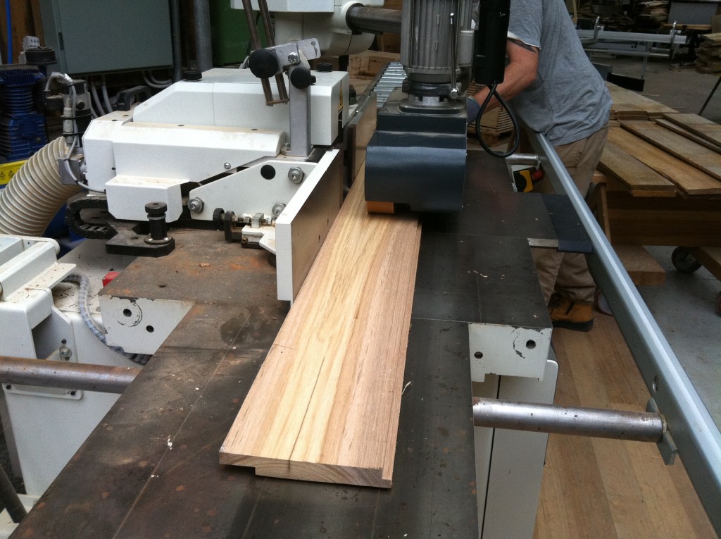 Passing through: Adam feeding a board through the profile machine to cut the rebate to create the ship lap