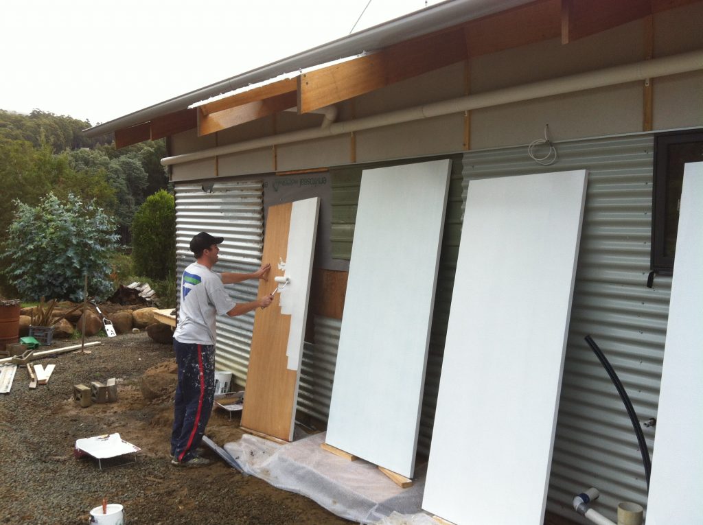 Easy does it: Gordon painting the internal doors outside