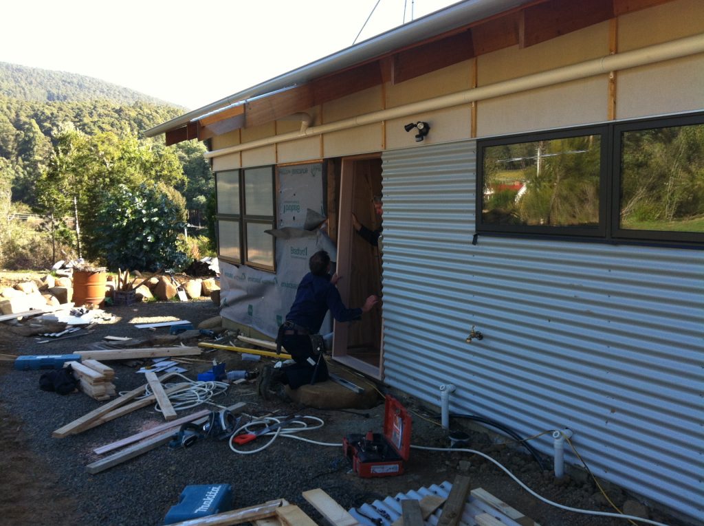 Formal entry: Greg & Pete installing the front door frame