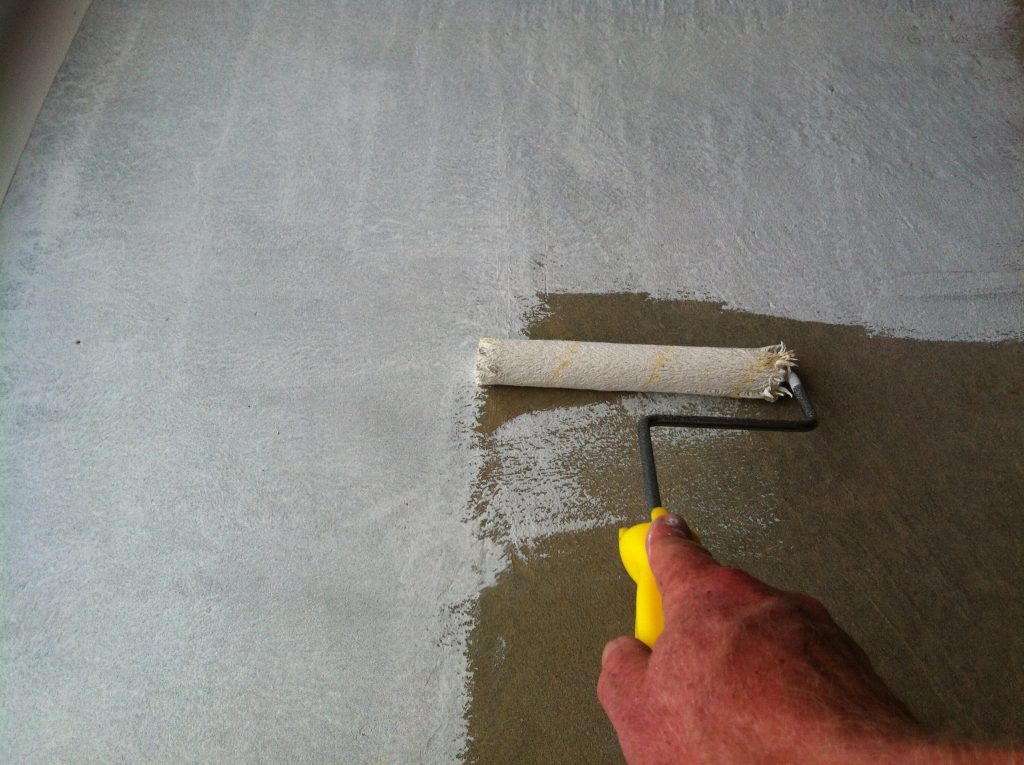 Thirsty: the raw concrete soaked up the first coat of epoxy