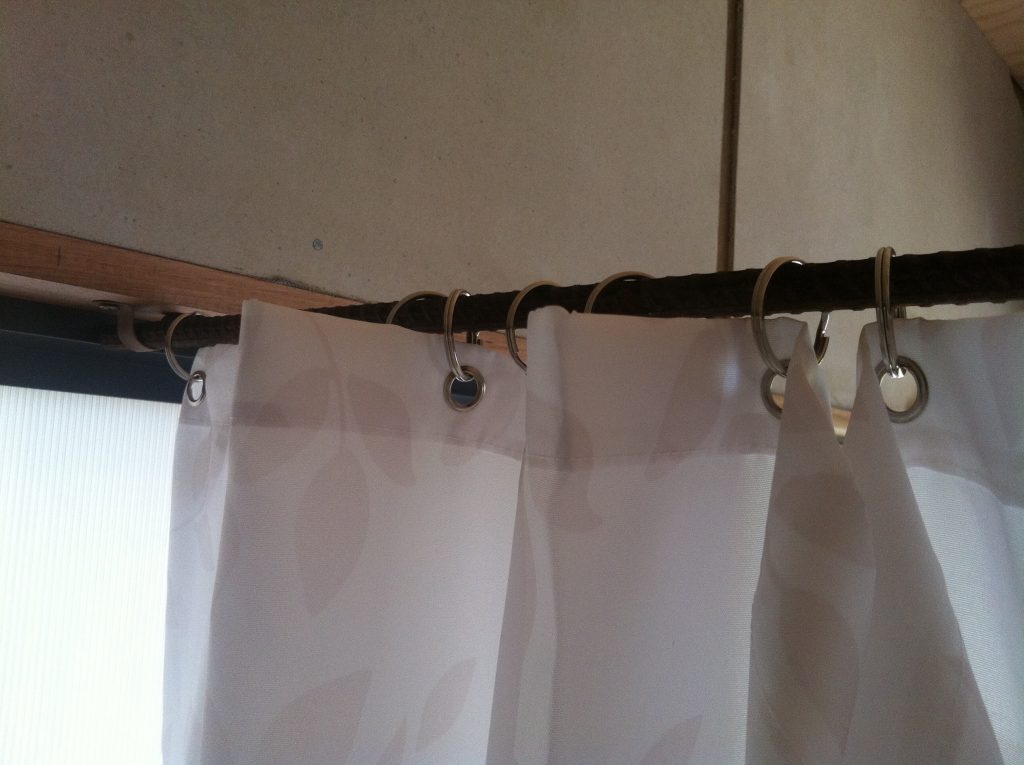 Rough and ready: the rebar reinforcing rod used for the shower curtain rail, and key rings for the eyelets